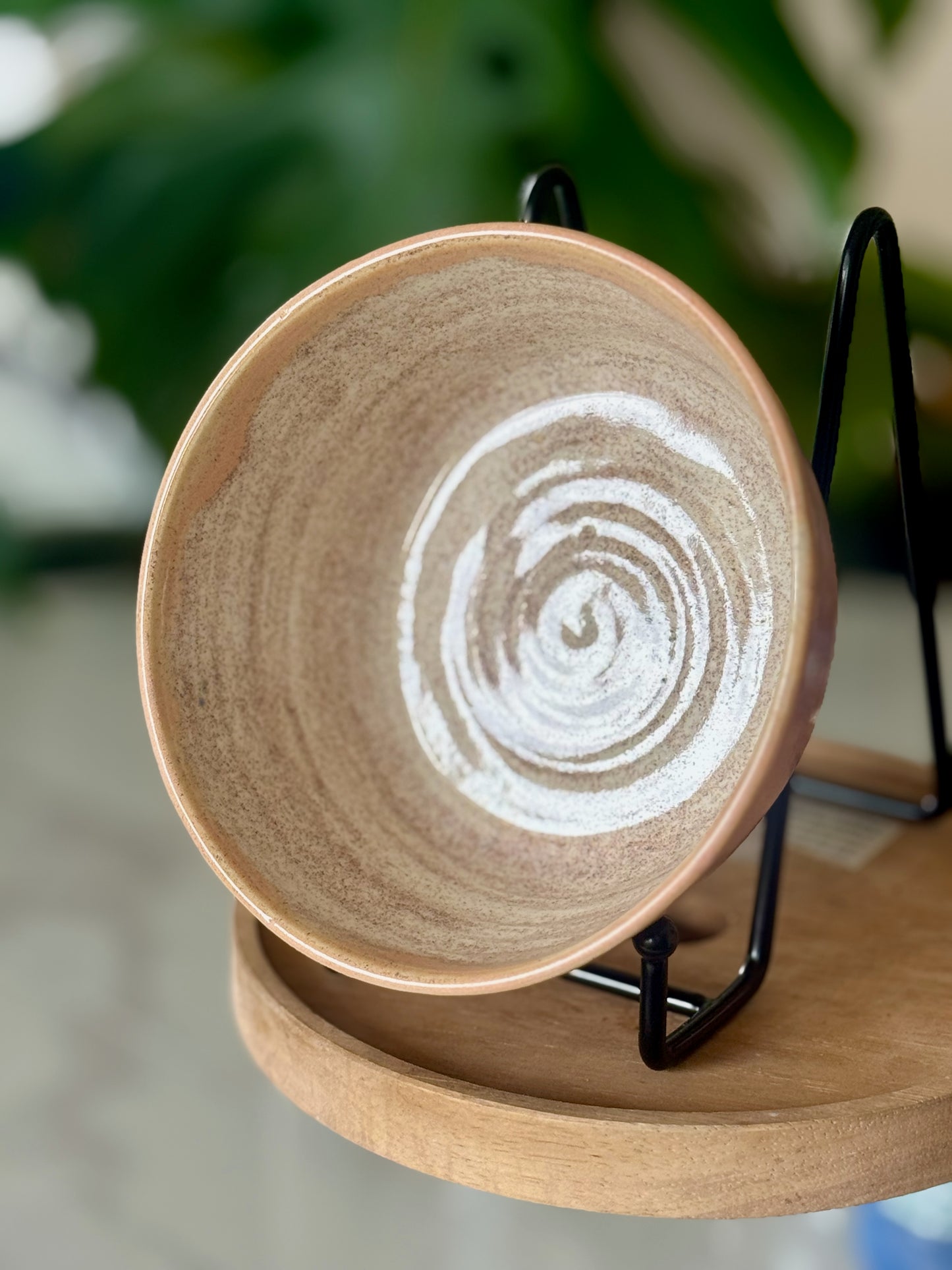 Spiral glaze bowl top view showing hand-painted white spiral on sandy interior