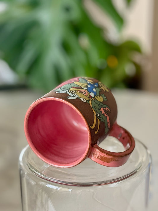 Frog Thor and Crocodile Loki Get Help mug bottom view showing pink glazed interior and handle
