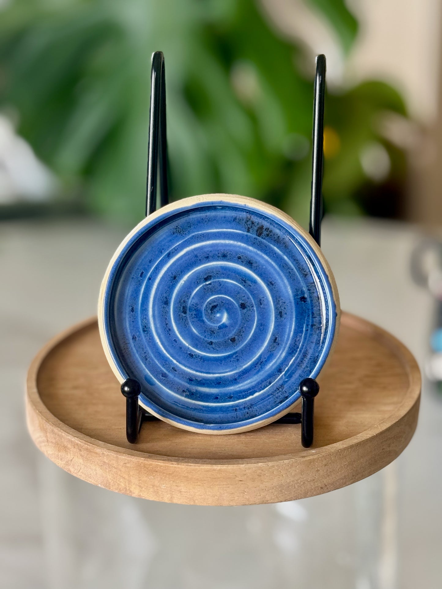 Blue spiral spoon rest showing cobalt glaze with hand-carved concentric spiral and sandy unglazed rim