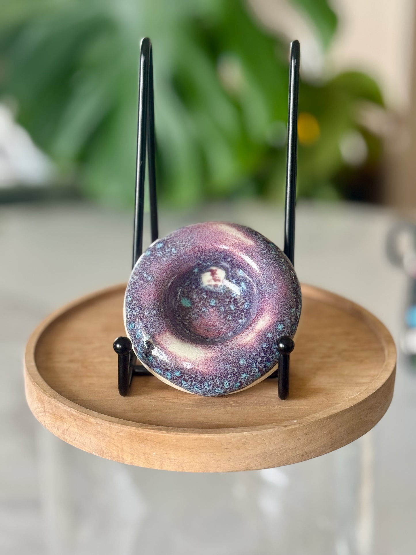 Galaxy glaze ashtray showing swirling purple, teal, and pink glaze with deep pooled center