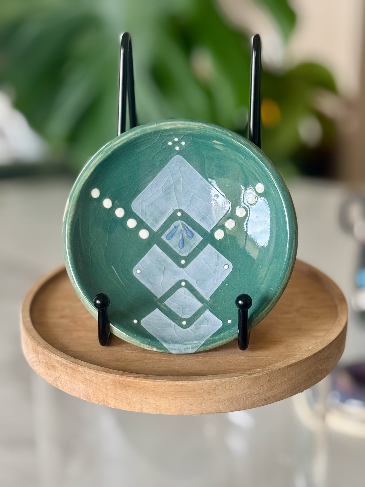 Teal slip-decorated trinket dish showing geometric diamond pattern and white dot accents on teal crackle glaze
