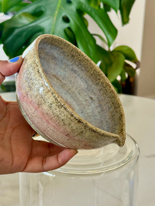 Glazed spouted bowl side view showing speckled exterior and spout