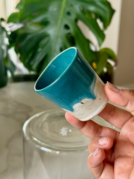 Teal dip glazed shot glass showing teal interior and white exterior