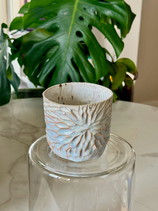 Carved sunflower mug front view showing deeply carved floral pattern