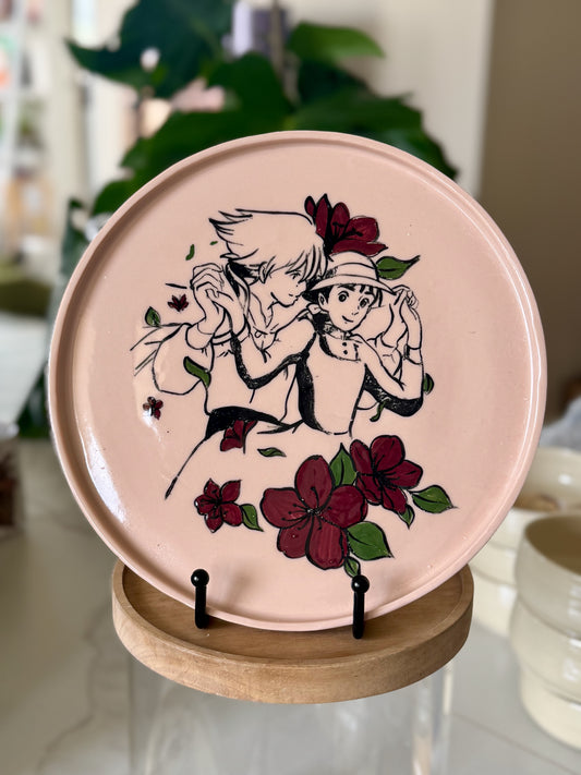 Howl and Sophie decorative plate with deep red floral border on blush pink glaze