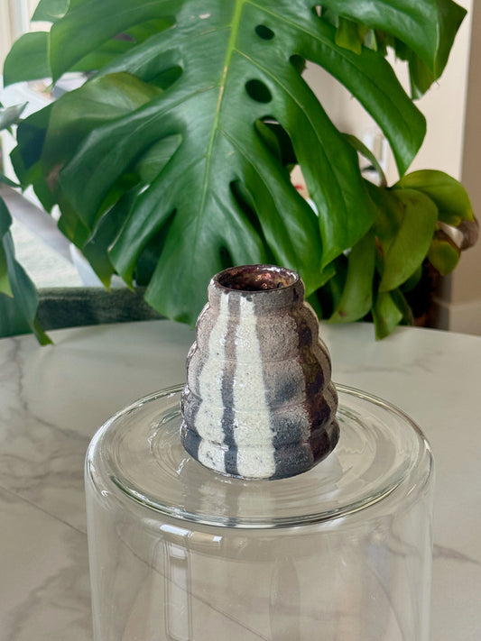 Abstract raku bud vase side view showing tiered ridges and glaze variation
