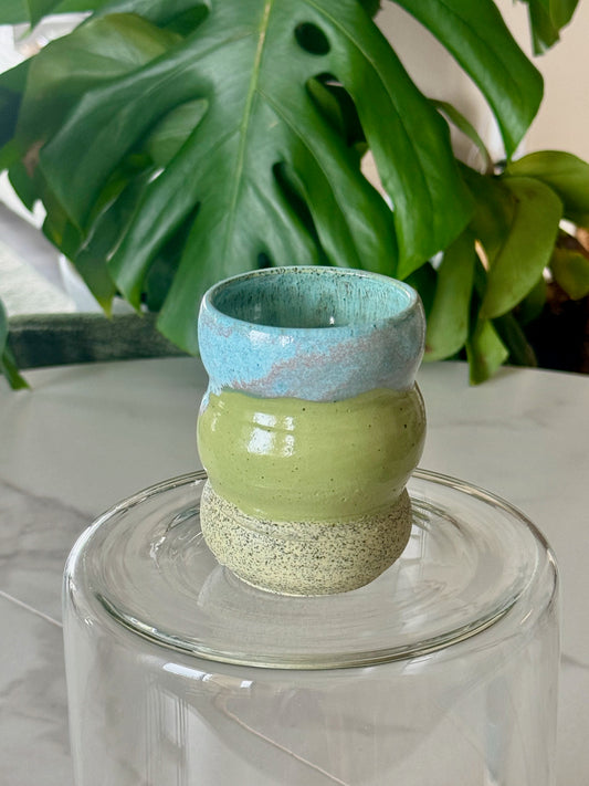 Bubble cup front view showing olive green body and sky blue rim