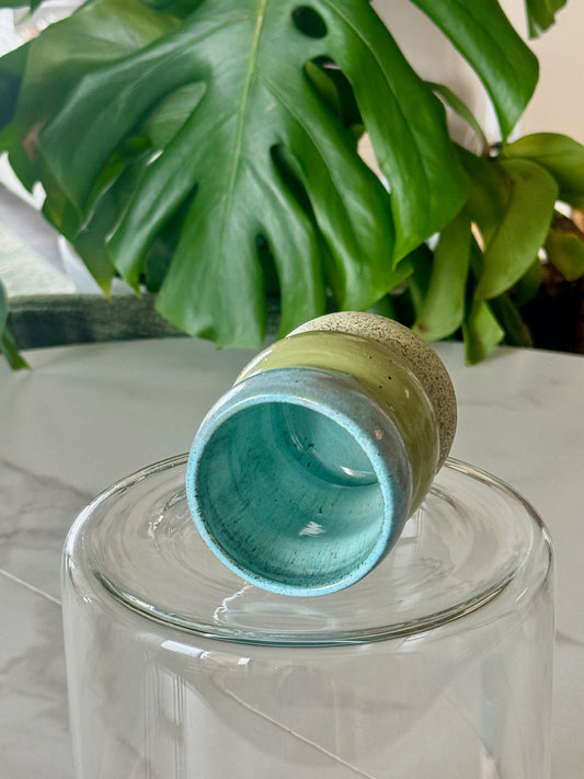 Bubble cup bottom view showing teal interior and speckled sandy base