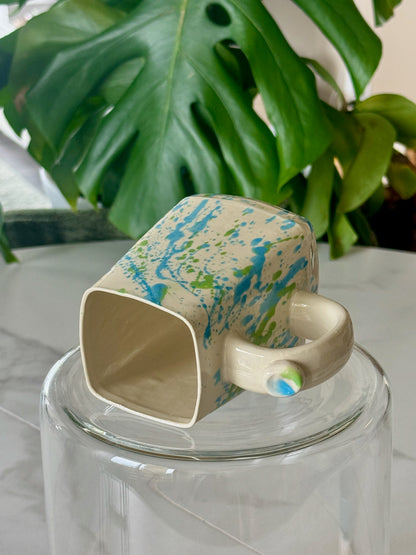 Splatter square mug bottom view showing square form and handle ball detail