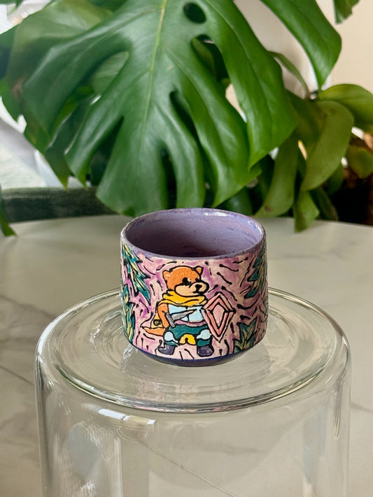 D&D otter adventurer mini cup showing illustrated otter in gear on purple glaze with botanical pattern