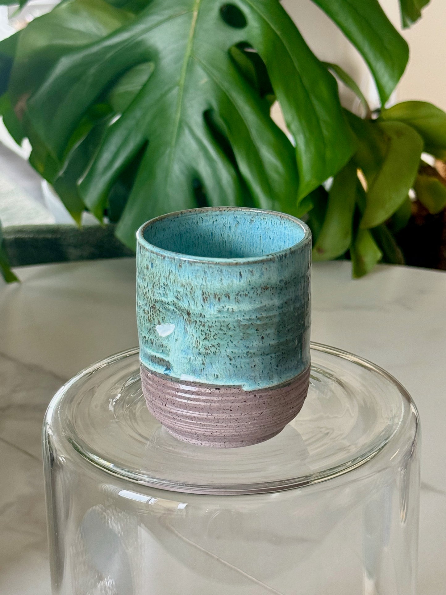 Lime green thumb cup with lavender speckled base