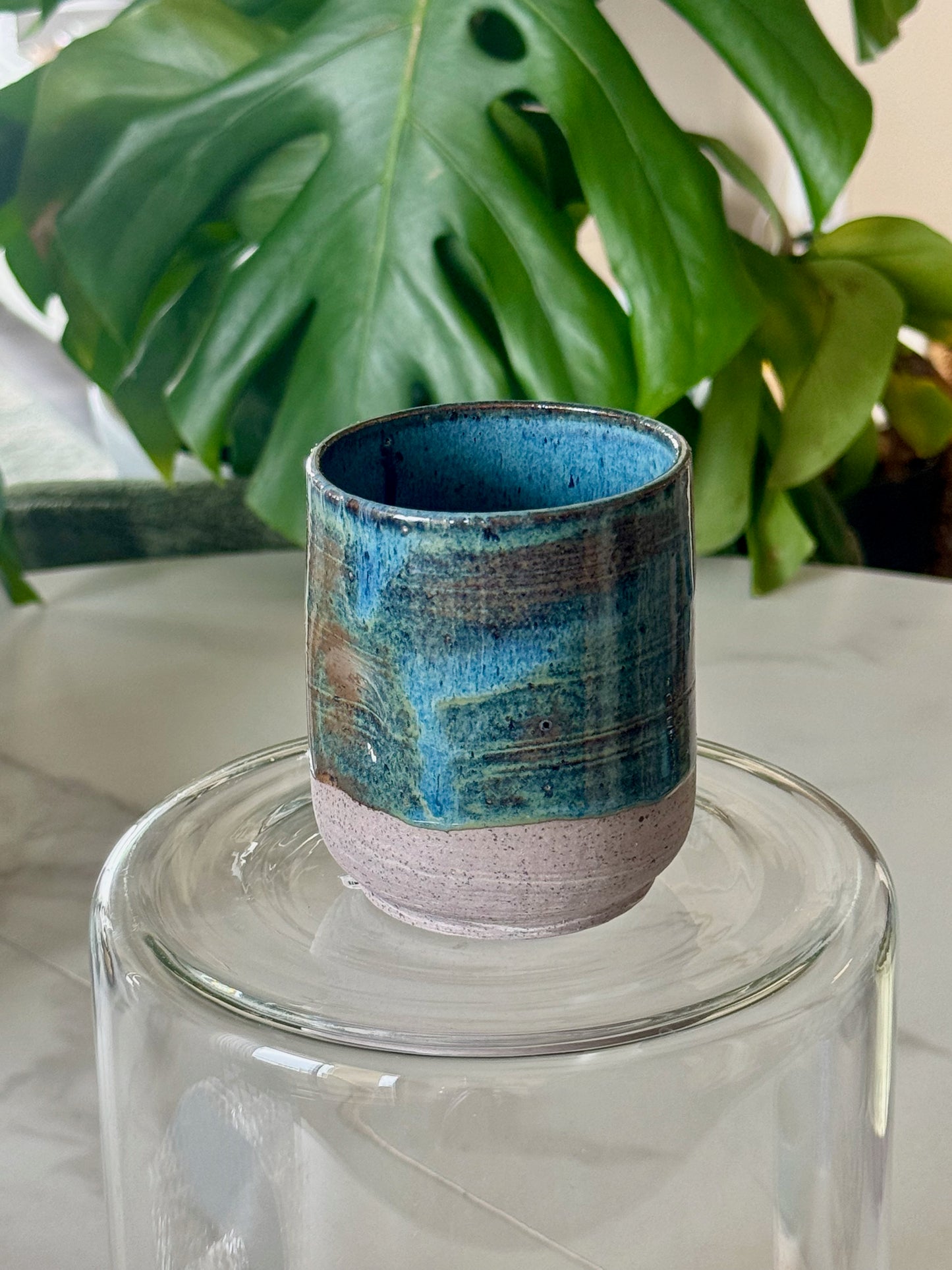 Cobalt blue drip glaze thumb cup with pink speckled base