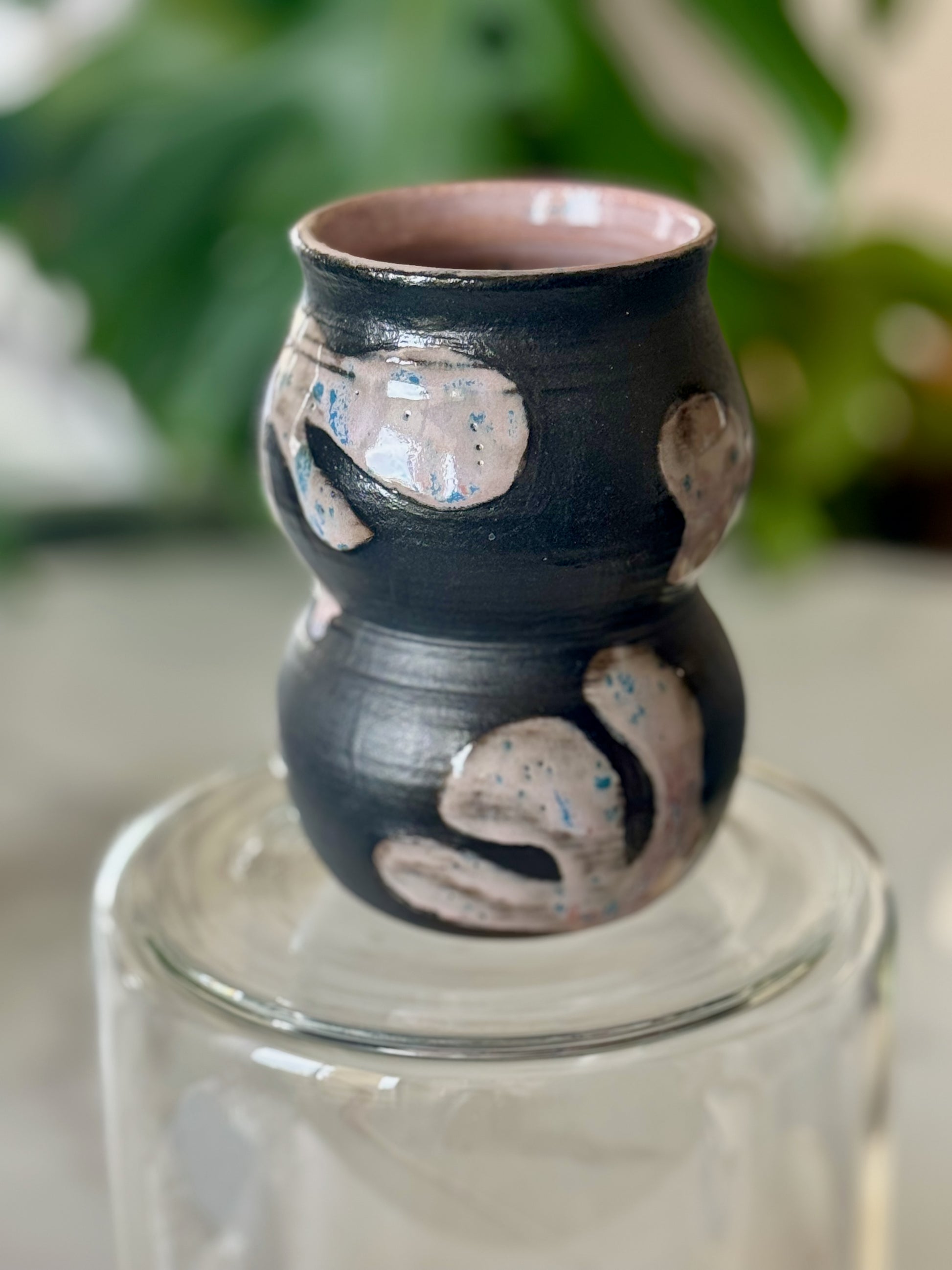 Abstract double-bubble vase side view showing sculptural double-bubble form and pink glazed interior