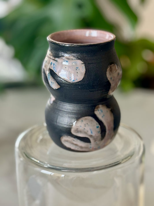 Abstract double-bubble vase side view showing sculptural double-bubble form and pink glazed interior