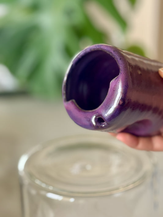 Ghost cow Halloween travel cup top view showing spouted rim and deep purple glazed interior