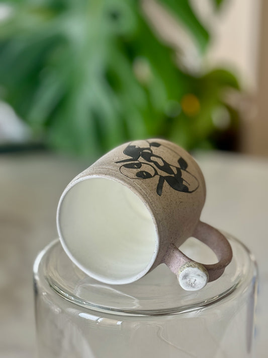 Deadpool heart mug bottom view showing white glazed interior and pink handle with white clay accent