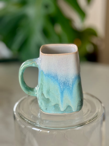 Ocean wave square mug front view showing white to blue to teal drip glaze and square opening