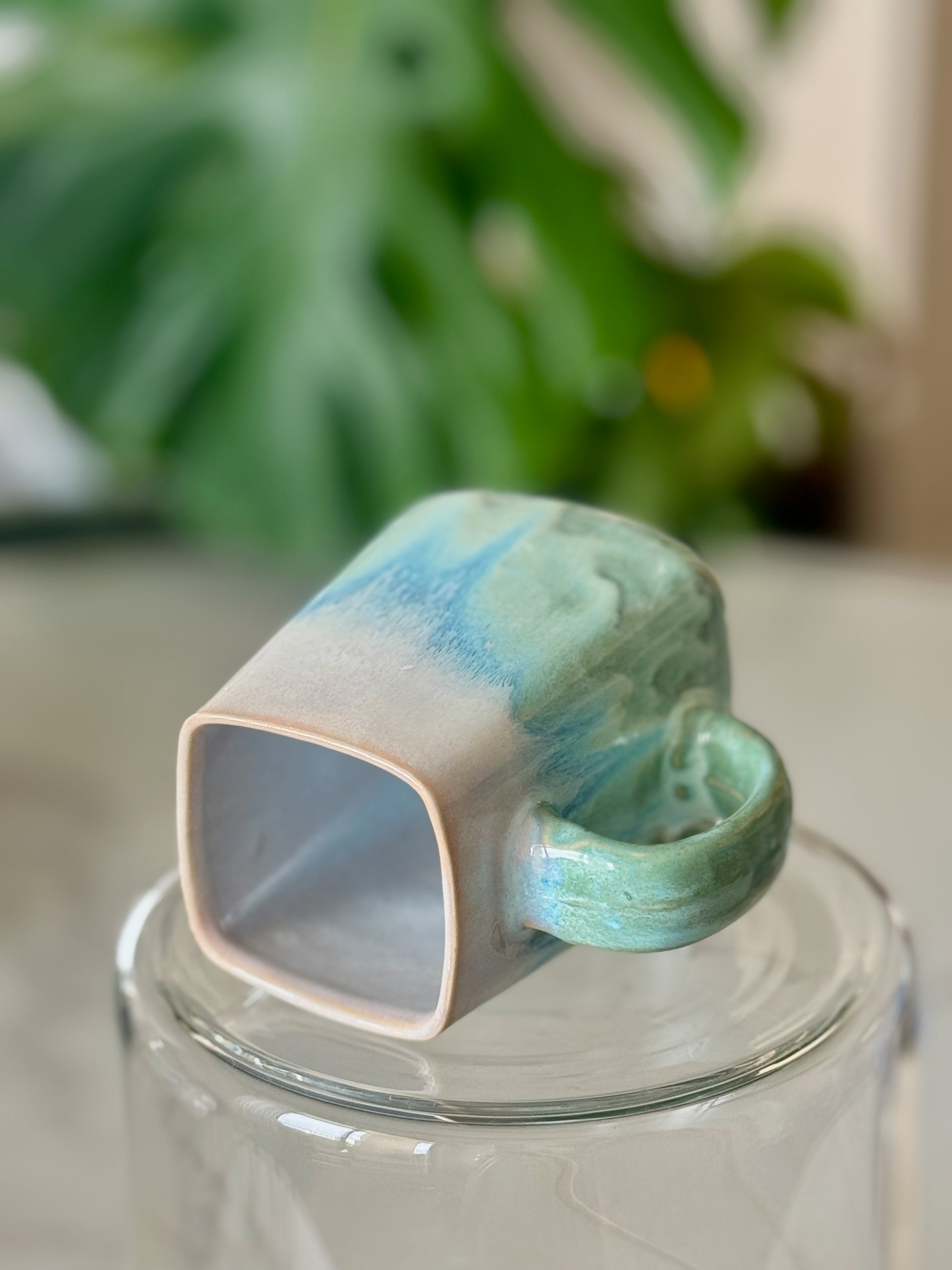 Ocean wave square mug bottom view showing square form and teal glaze on handle