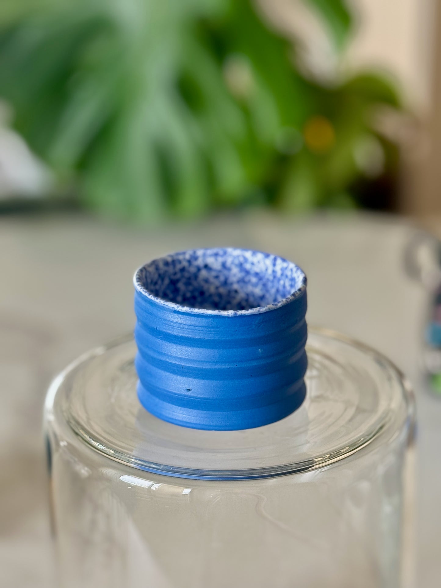 Mini ribbed espresso cup top view showing speckled blue glazed interior